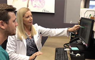 doctor explaining data on computer