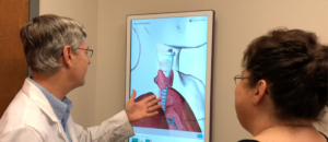 doctor explaining imagery of Thyroid Cancer to patient